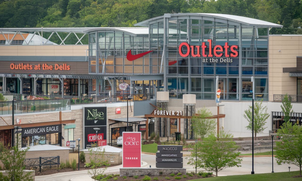 Outlets at the Dells featuring a vibrant shopping scene with stylish storefronts and happy shoppers.